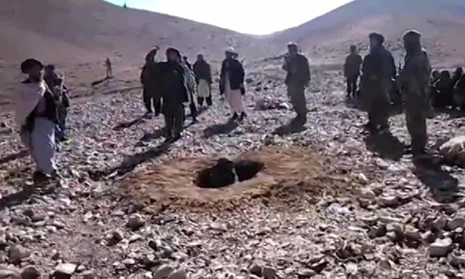 Men stoning a woman in Afghanistan