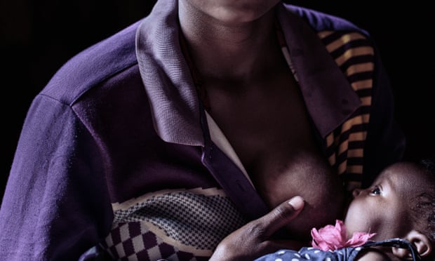 A woman breastfeeds her small daughter in Rwanda.