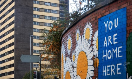 Sign saying You are Home Here by tower block