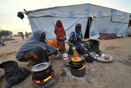 Nigerian refugee women cook in a United Nations Refugee Agency (UNHCR) refugee camp in Baga Sola by Lake Chad, which borders Chad, Nigeria, Niger and Cameroon, on January 26, 2015. Since the beginning of January more than 14,000 people have fled over the Nigerian border into Chad to escape the bloody attacks by Islamist group Boko Haram around Baga.