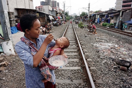 Indonesian woman feeds child