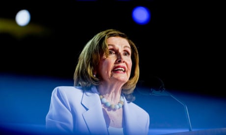 a woman in a suit speaks into a microphone