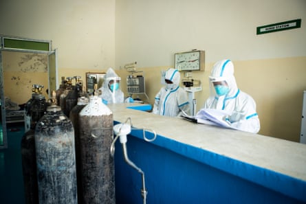 Nurses are seen behind the counter of the treatment ward in De Martini hospital.