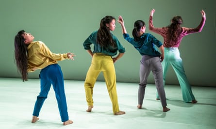 Sung Im Her, leaning to the left and in a row  with three other female dancers, all with long hair and wearing long-sleeved shirts and trousers, performing W.A.Y. (Re-Work) 