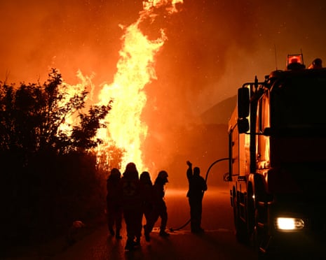 Firefighters work to extinguish a wildfire near the city of Patras, western Greece.