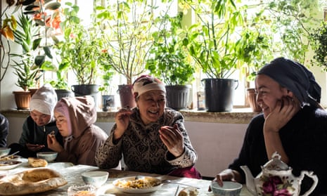 Buunisa Termechikova eats pilaf with her daughter and other guests at home in Burgan-Suu village.