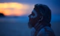 People Observe Australia Day Holiday<br>SYDNEY, AUSTRALIA - JANUARY 26: Matthew Doyle looks on at Bondi Beach for a Dawn Reflection and Smoking Ceremony on January 26, 2024 in Sydney, Australia. Australia Day, formerly known as Foundation Day, is the official national day of Australia and is celebrated annually on January 26 to commemorate the arrival of the First Fleet to Sydney in 1788. Many indigenous Australians refer to the day as 'Invasion Day' and there is a growing movement to change the date to one which can be celebrated by all Australians. In 2024, supermarket Chains Woolworths and Aldi announced that they would stop stocking themed merchandise for the day, drawing a political backlash from opposition leader Peter Dutton. (Photo by Jenny Evans/Getty Images)