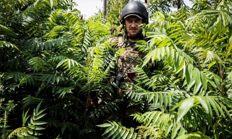 A Ukrainian soldier moves between positions at an undisclosed location in the Donetsk region
