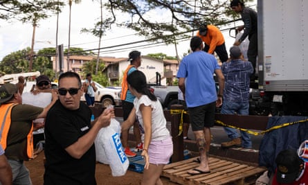Volunteers unload donations at a distribution center for those affected by the Maui fires at Honokawai Beach Park in Napili-Honokowai, west of Maui, Hawaii, on Monday.
