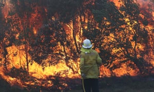 A firefighter works to contain a bushfire in Angourie, New South Wales