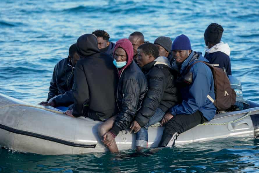 Nine migrants drift in the English Channel after their engine failed in Dover, 6 September. They were making their way to the South Coast of England when their outboard motor failed and only had one life jacket amongst them