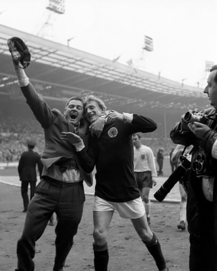 Denis Law celebrates Scotland’s win against England in 1967 alongside a very enthusiastic supporter.