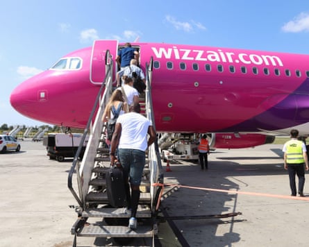 Passengers board a Wizz Air aircraft