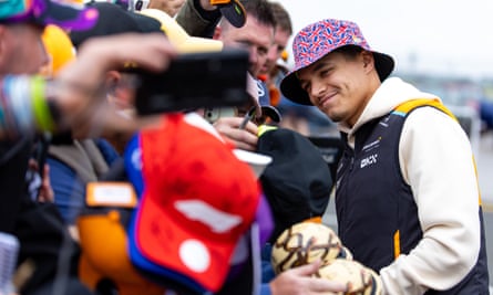 Lando Norris greets fans outside the paddock during practice ahead of the British Grand Prix at Silverstone on 5 July 2024