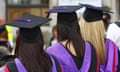 women graduates in purple-edged graduation capes and mortar board hats