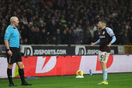 Emiliano Buendia (R) appeals to the assistant referee Mat Wilkes