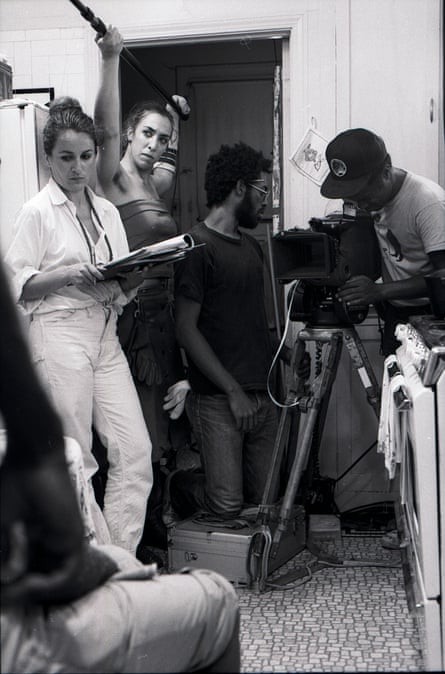people standing around a camera