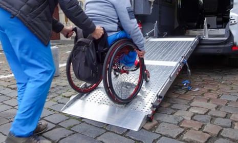 Disabled person on wheelchair using car lift