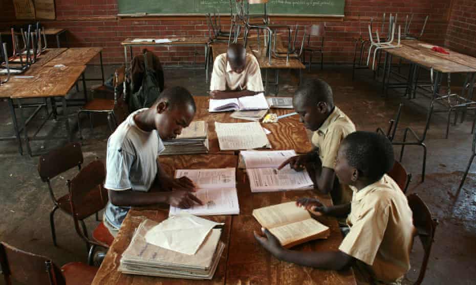 Children sit at their desks inside their classroom in Harare, Zimbabwe. UNICEF estimates that in Zimbabwe, an average of 10 children share a single text book and some schools have no books at all.