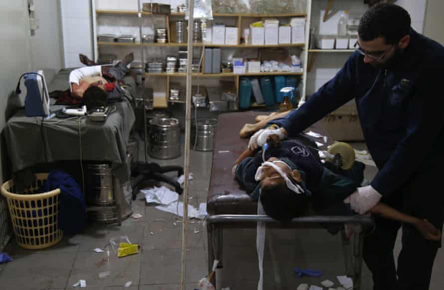 Wounded Syrians receive treatment in a makeshift clinic in eastern Ghouta