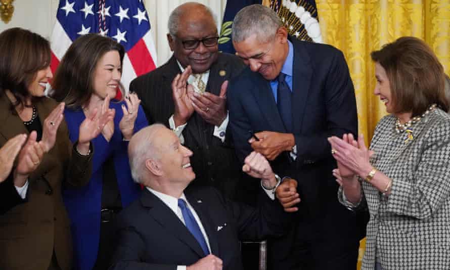 Joe Biden fist-bumps Barack Obama after Biden signed an executive order aimed at strengthening the Affordable Care Act.