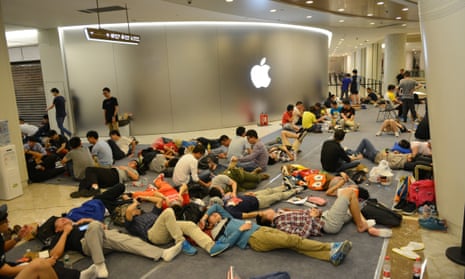 People queue outside the Apple store in Nanjing before its opening on Saturday. 