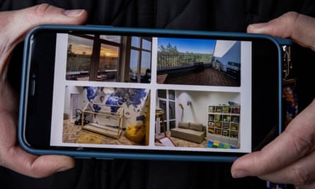 Psariova holds up her phone as she shows photos of what her apartment used to look like