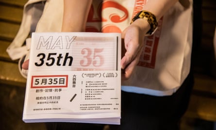 A woman reads the script of the May 35th play about the massacre on a bench in Victoria Park