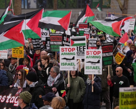 People marching with Palestinian flags and placards