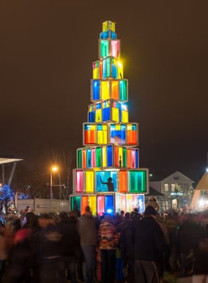 People visit a12 meter high Christmas tree constructed of 121 old windows that come from local old houses as it is illuminated in Rakvere, Estonia.