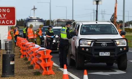 Victorian police and Australian defence force personnel manage roadside checkpoints near Donnybrook on Wednesday to enforce coronavirus travel restrictions.