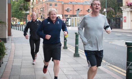 Boris Johnson (centre) takes an early morning run at the conference.