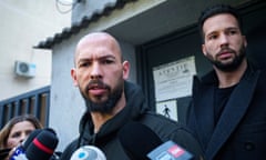 Andrew Tate and Tristan Tate surrounded by microphones as they exit a doorway