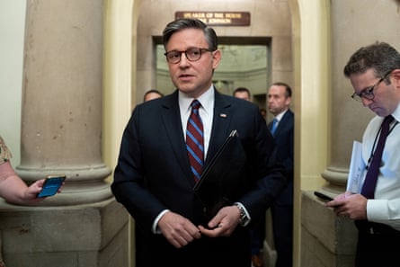 Johnson stands in front of an open door into his office, facing the camera but looking slightly to the side