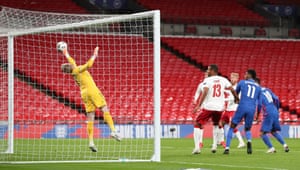 But he’s thwarted by the great reactions of Denmark’s keeper Kasper Schmeichel .