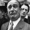 A Frenchman weeps as historic French battle flags are taken out of Marseille for safekeeping in 1941.