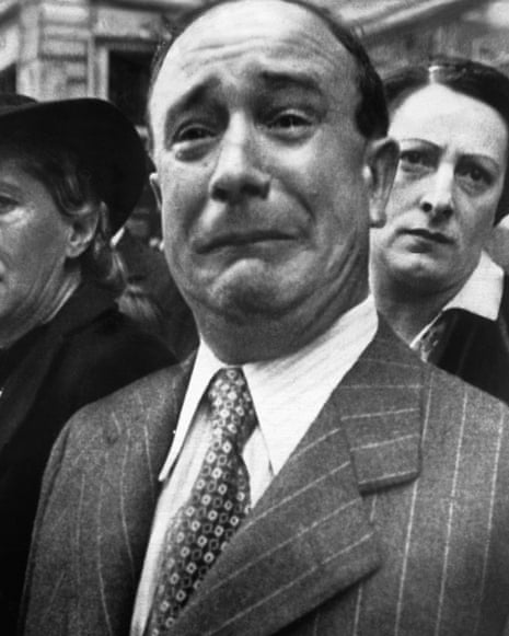 A Frenchman weeps as historic French battle flags are taken out of Marseille for safekeeping in 1941.