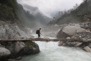 Tikka passes over a torrent as the monsoon makes its presence felt