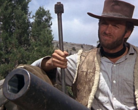 Clint Eastwood in a cowboy hat and sheepskin vest loads a cannon with a ramrod outdoors