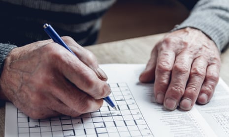 Older person playing a crossword or similar puzzle game