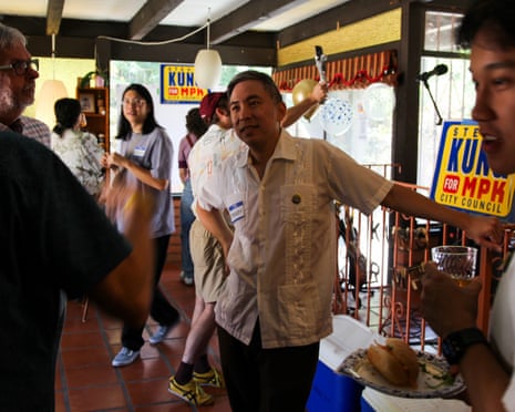 a man speaks with supporters