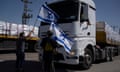 FILE - Activists stand in front of trucks carrying humanitarian aid as they try to stop them from entering the Gaza Strip in an area near the Kerem Shalom border crossing, southern Israel, Thursday, May 9, 2024. (AP Photo/Leo Correa, File)