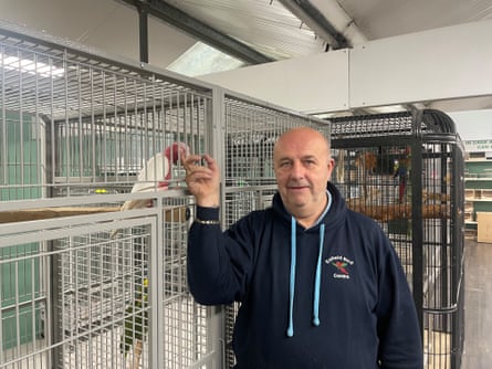 Trevor Wyllie with a caged parrot