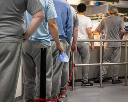 A queue of men in a canteen.