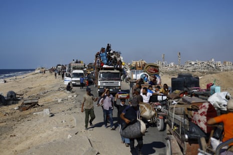 Palestinians, carrying their belongings by vehicle or on their backs, continue to flee toward southern Gaza via al-Rashid Street after intensified Israeli attacks and ground operation amid forced evacuation orders in Gaza City, Gaza on 26 September 2025.