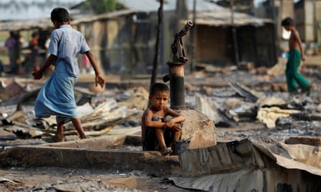 A boy sit in a burnt area after fire destroyed shelters at a camp for internally displaced Rohingya Muslims in the western Rakhine State near Sittwe, Myanmar May 3, 2016. 