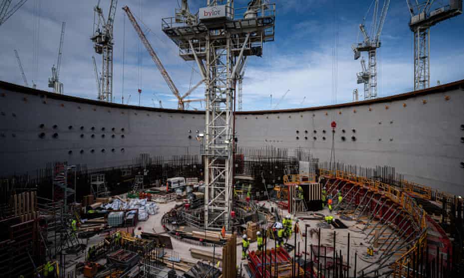 Workers surround the base of a crane in the centre of the circular reinforced concrete and steel home of a reactor at at Hinkley Point C nuclear power plant near Bridgwater in Somerset.