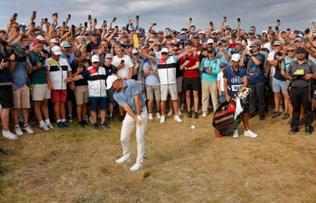 Rory McIlroy plays his second shot on the 17th hole after taking a free drop from where he sliced his tee shot over a fence near the 18th tee during day four of the Open.