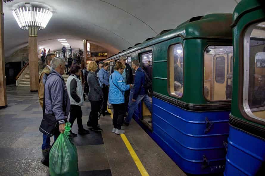 Locals board a metro as city officials restarted the metro service in Kharkiv, Ukraine.