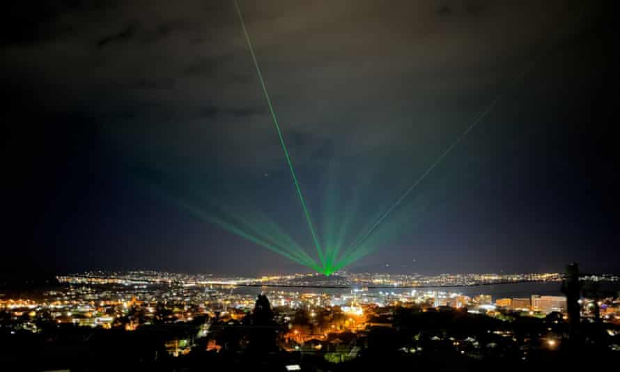 The Beacon casts laser beams into the night sky